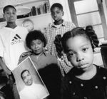 The death of Michael Ealy in a struggle with police was found justified. His mother, Ophelia (center), filed a $1 million claim; two officers have countersued, saying her suit is an "injury" to them.