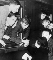 Dutch women greet children on an England-bound train.
