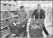 Luis Guzman and Sandler go merrily shopping.