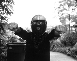 Bob Log III reaches out for (a) a drink and (b) something to stir it with.