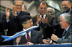 The governor with the 7E7 in his grasp at the big announcement in December.