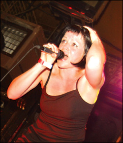 Bre Loughlin holds on to her head while Dave Dayton playes on.