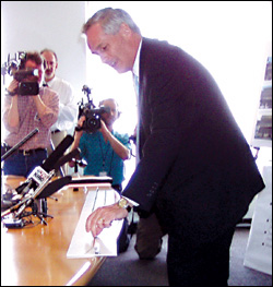 At his news conference, Jon Magnusson explains to reporters the problems with building part of the system with one track instead of two.