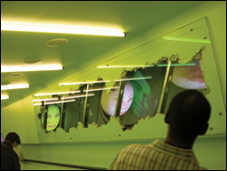 Oursler's Commu: murmuring heads on the escalator.