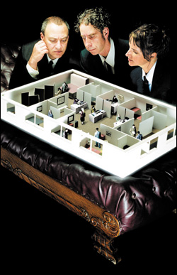 Filmmakers Mark Achbar, Joel Bakan, and Jennifer Abbott (from left) contemplate a model of their subject.