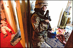 Female soldiers, like this one on a raid in Samarra earlier this year, are used to reassure civilians and defuse potentially violent confrontations.
