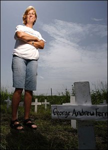Near Crawford, Texas, Cindy Sheehan stands among crosses symbolizing soldiers who died in Iraq.