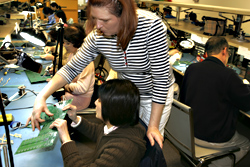 Wrestling with circuit boards at the Refugee Federation Service center.