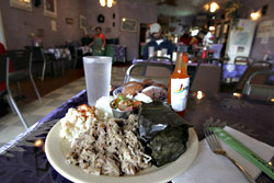 Hey, ho, the gang's all here: kalua pig, lau lau, tomi tomi, and malasadas.