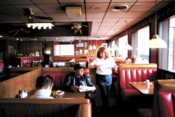 Cyndys server runs to get hot food out fast.