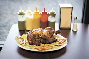 San Fernandos pollo a la brasa, with sauce-painting apparatus.