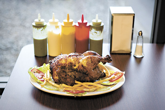 San Fernandos pollo a la brasa, with sauce-painting apparatus.