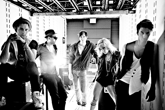 Why is the Sounds only female member also the only person in the photo not wearing pants?