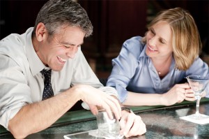 Road warriors Clooney and Farmiga connectwhere else?at the airport bar.