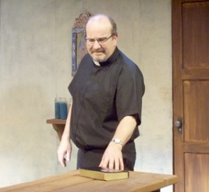 Burgess as the neurotically upbeat Father Doherty.