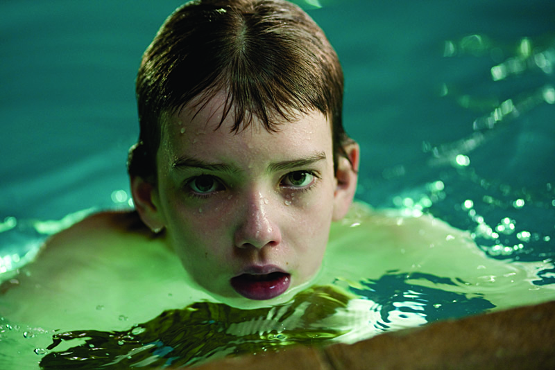 Smit-McPhee as the bullied boy in need of a protector.