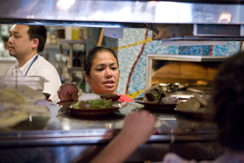 Owner and chef Maria Hines running the expo window at her restaurant, Golden Beetle.