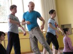 Ohlberg (center, in blue) rehearses his dancers.