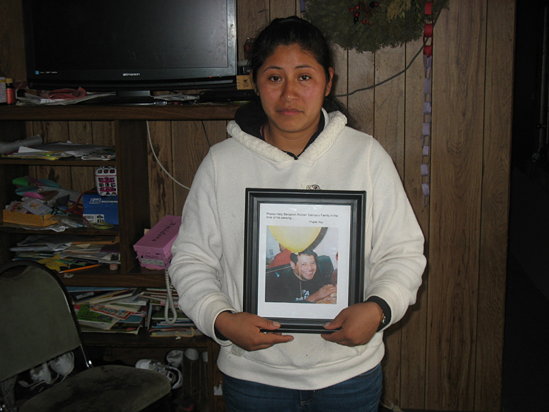 Crisanta, holding a picture of her boyfriend who drowned.