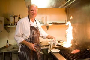 Chef Szmania seasons and cooks a New York steak.