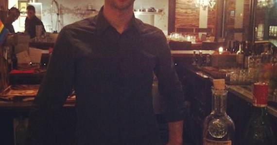 Hudak stands before his canvas.