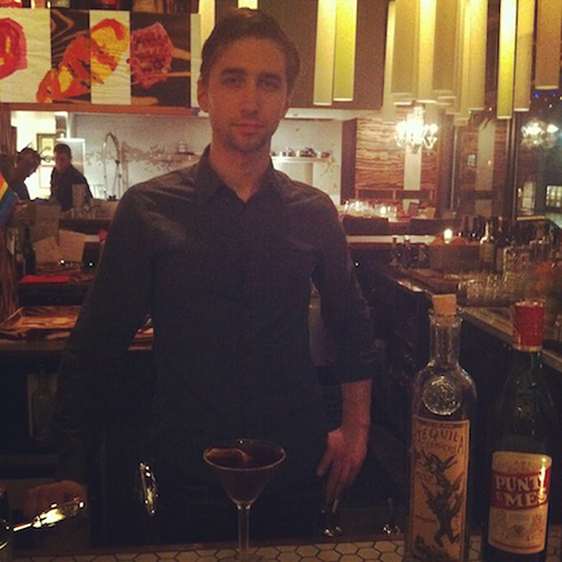 Hudak stands before his canvas.