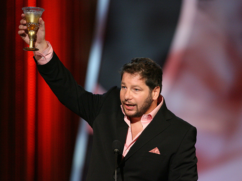 The king of the celebrity roast, shown offering a toast.
