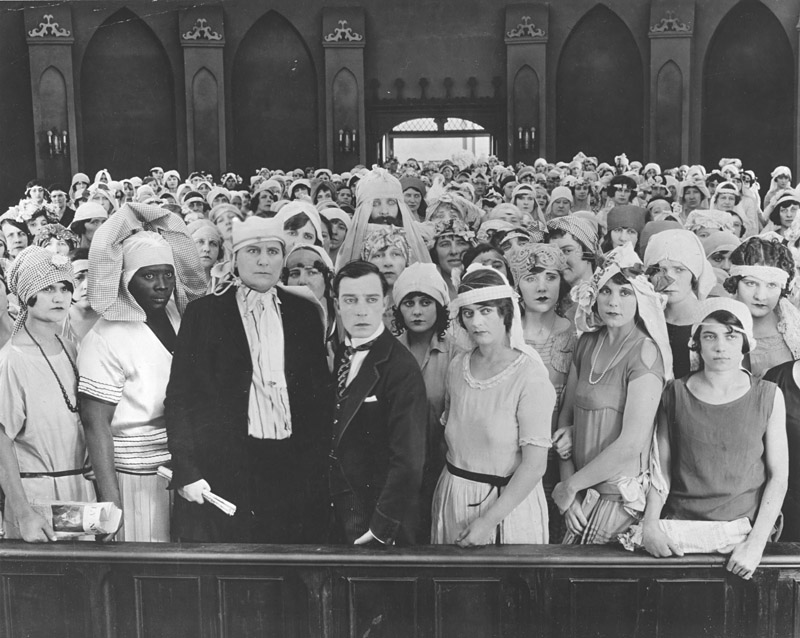 Keaton (center) surrounded by potential brides in Seven Chances.