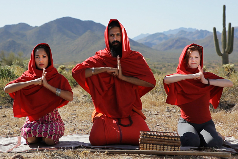 The director (center) as fake cult leader.