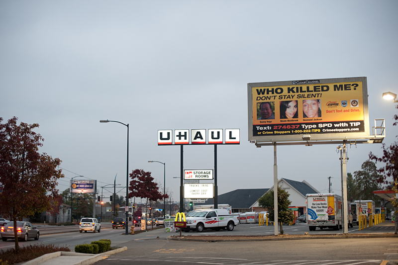Vega, Westbrook, and Jackson, pictured on a Crime Stoppers billboard.