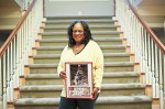 Terry's mom holds a framed photo of her son's highlights.