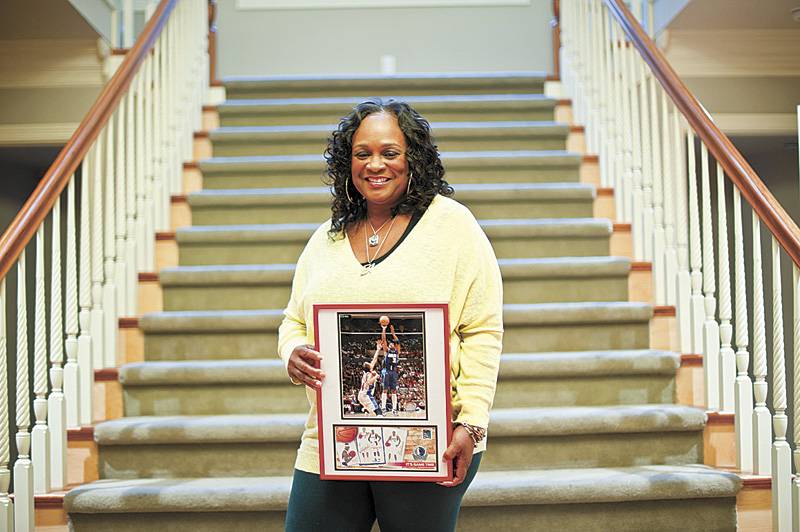 Terry's mom holds a framed photo of her son's highlights.