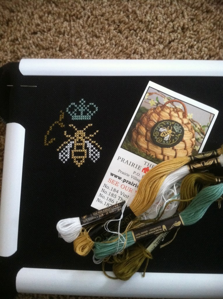 I'm stitching the Prairie Schooler bee on 28 count black. The black fabric is a challenge.