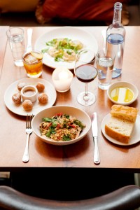 From the vantage point of a table set with drinks and a few slices of rustic housemade focaccia, it seems impossible for the evening to go awry. Top left: house-cured pork loin. Bottom left: cauliflower soup.