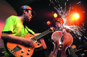 Ken Sakamoto (left) watches Hiromichi Sakamoto grind his cello.