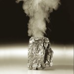 Piece of coal with smoke coming out of top