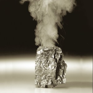 Piece of coal with smoke coming out of top