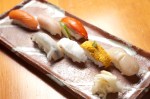 Sushi assortment of sea scallop, sea urchin, Columbia springer, copper liver, sockeye, herring, and albacore tuna belly