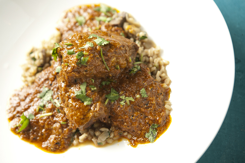 Undercooked shortribs, slathered with a mahogany-colored tomato cream curry, would have benefited from a shake of salt.