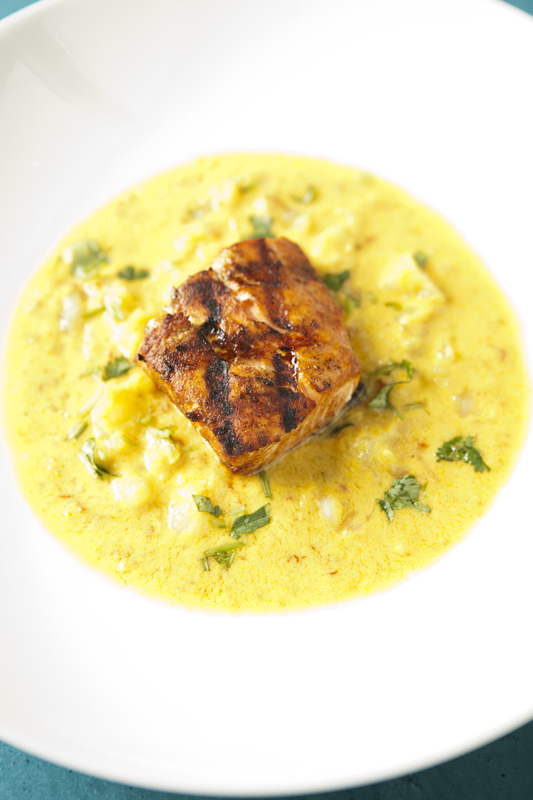 Overcooked salmon needed more zip than a sheer curry of coconut and ginger offered.