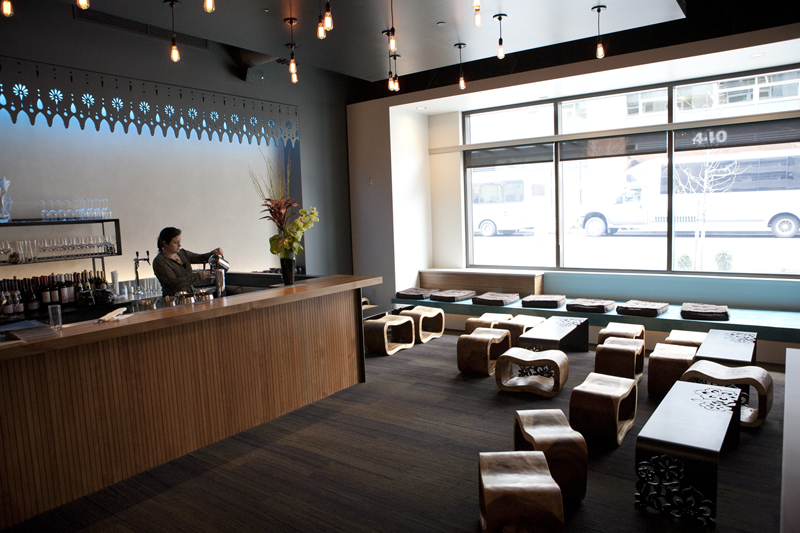 At the back end of its boxy dining room is a conspicuously posh lounge, furnished with exposed light bulbs, an elaborately cut-out cornice, scrolling wooden benches and darker wooden tables of the same squat height.