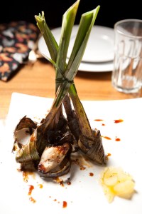 While you pine for larb and massaman curry, I'll be eating gai haw bai thoey, a gleefully tactile starter of three tender chicken bits, each bandaged in an untrimmed emerald green pandan leaf, its forearm-long ends jutting skyward like especially perky onion tops. The marinated chicken bundles are seated in a slick of sesame oil, ginger and syrupy pineapple chunks—so they're sweetly sticky both inside and out. The perpendicular dish is a sugary, southeast Asian spectacle, something like what you hope to get when you order food at a tiki bar.