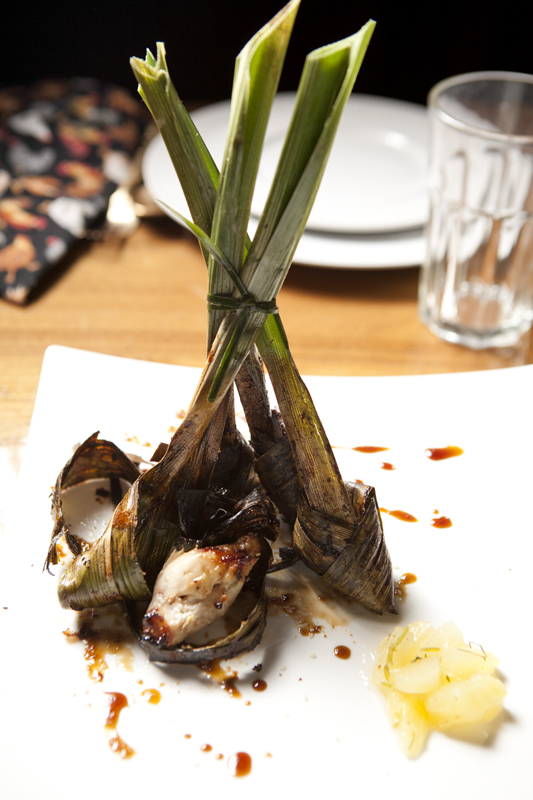 While you pine for larb and massaman curry, I'll be eating gai haw bai thoey, a gleefully tactile starter of three tender chicken bits, each bandaged in an untrimmed emerald green pandan leaf, its forearm-long ends jutting skyward like especially perky onion tops. The marinated chicken bundles are seated in a slick of sesame oil, ginger and syrupy pineapple chunks—so they're sweetly sticky both inside and out. The perpendicular dish is a sugary, southeast Asian spectacle, something like what you hope to get when you order food at a tiki bar.