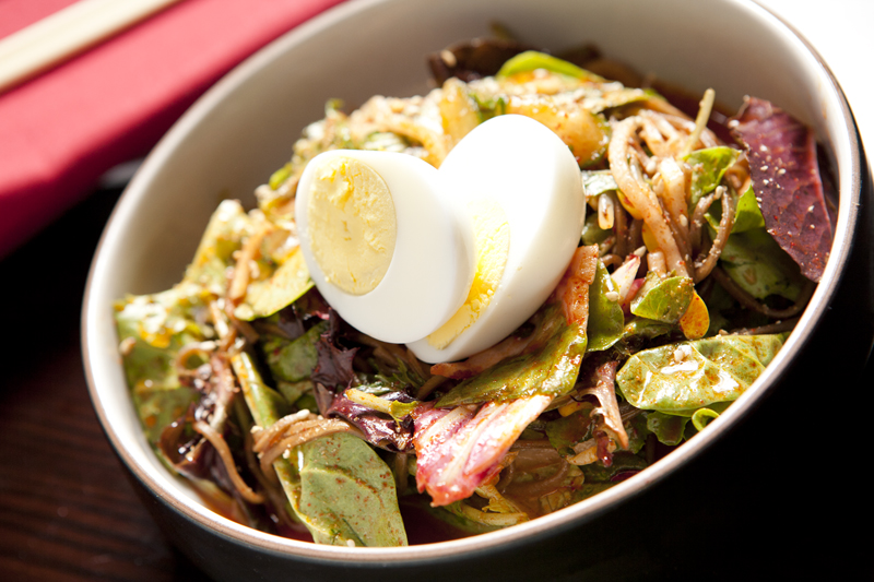 Cold buckwheat noodles in a zingy vinaigrette are the beneficiaries of a medley of cucumbers, cabbage and red onion.