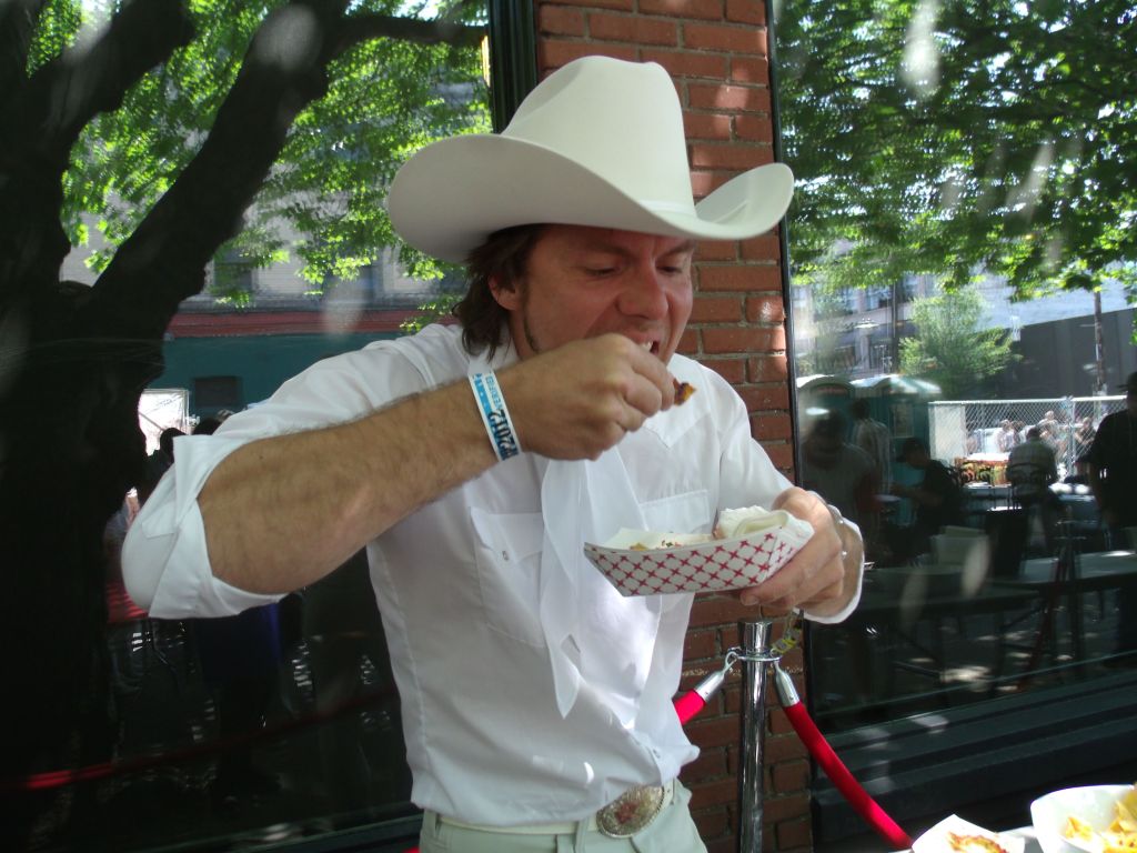 This is why Johnny Cash wore black. Ben from Brent Amaker and the Rodeo takes on Poquitos chips and salsa in the VIP tent.