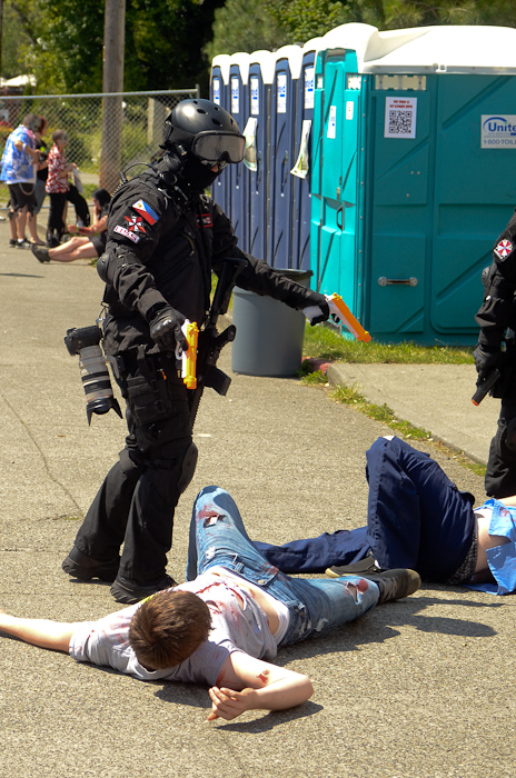 Another armed survivor dispatches a couple of zombies.