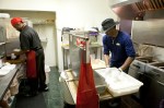 Chef Willie and Ezell working together in their kitchen.