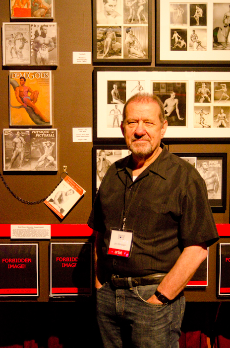 Jim Wilkinson stands with a small slice of his installation that catalogs the last 60 years of homoerotic photography and art, from an age of suppression to an era of surplus.