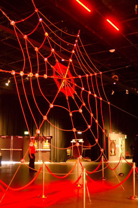 Le Petit Piege, a massive metal spider web masterminded by Kevin MacDonald, dominates the entry atrium, spanning 20 feet vertically and 40 feet horizontally. It is a unique event space for bondage and aerial performances during the festival.