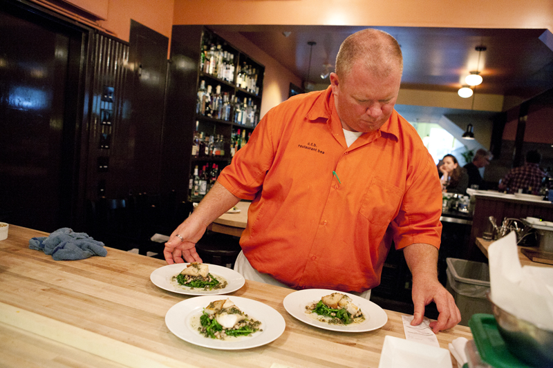 Chef Black looks over the orders before sending them out to tables.